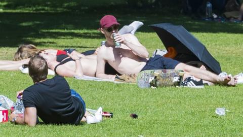 Sunbathers in The Meadows in Edinburgh