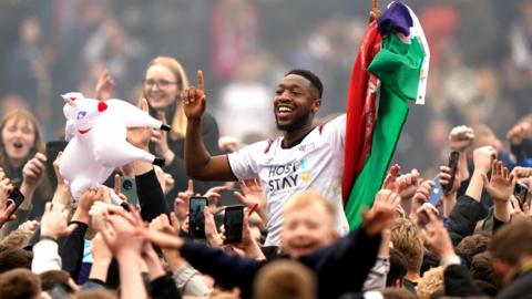 Derby County's Ebou Adams celebrates with fans after promotion was sealed