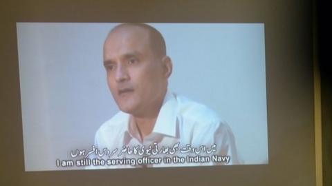 In this photograph taken on March 29, 2016, Pakistani journalists watch a video showing Indian national Kulbhushan Jadhav, arrested on suspicion of spying, during a press conference in Islamabad