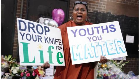 A woman protests against knife crime at the scene in Croydon, south London, where 15-year-old Elianne Andam was stabbed