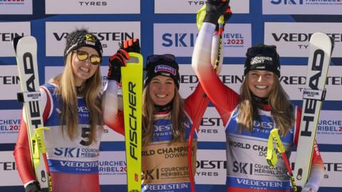 Switzerland's Jasmine Flury on the podium with Austria's Nina Ortlieb and compatriot Corinne Suter after winning the women's downhill at the World Ski Championships