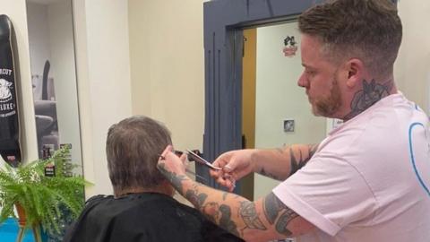 Kyle having his hair cut at the Croppers in Norwich