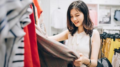 A person browsing clothes in a store