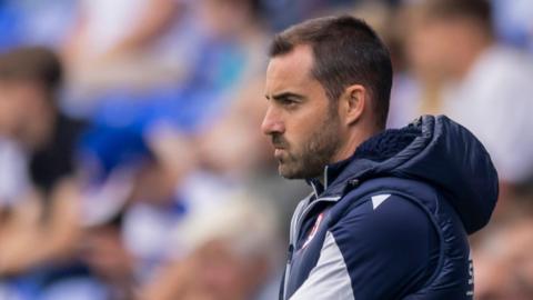 A tense Ruben Selles on the touchline during a League One match.