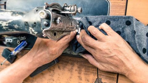 Man using a sewing machine