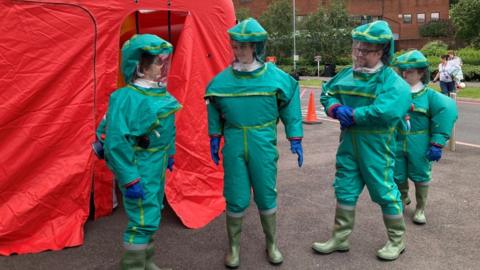 Staff in protective suits