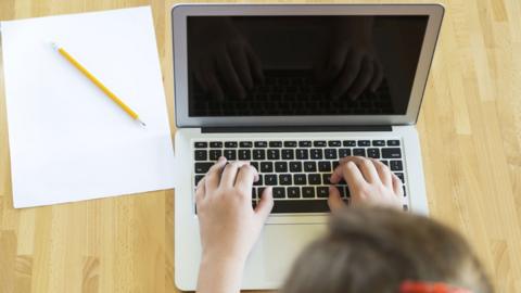 Schoolgirl using laptop