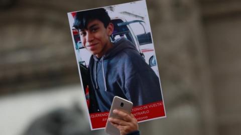 demonstrator holds up a poster with a picture of high school student Marco Antonio Sanchez, who disappeared in a protest march Angel of Independence in Mexico City, Mexico January 28, 2018.rtrs