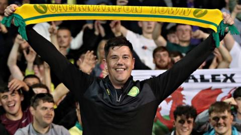 Richard Davies celebrates with Caernarfon fans following the win over Crusaders