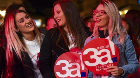 Voters in Skopje hold banners reading "Yes for European Macedonia"