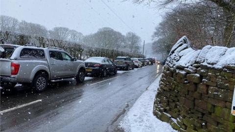 Cars parked on a road near Rivington Pike