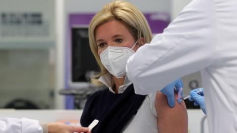 A medical professional is vaccinated against Covid-19 with Moderna"s vaccine in Essen, Germany, 18 January 2021