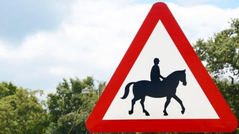 Beware horses UK triangle road warning sign