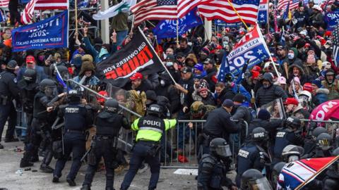 Trump supporters clash with police and security forces as they storm the US Capitol in Washington DC on 6 January 2021.