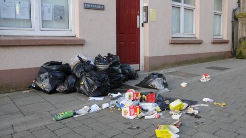 Strewn rubbish on a street in Aberystwyth