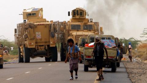 Yemeni forces backed by the Saudi-led coalition take position during an attack on the port city of Hudaydah, 13 June 2018