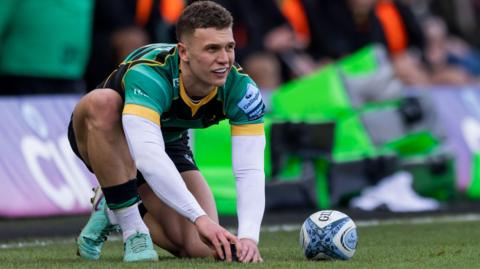 Northampton Saints' Charlie Savala prepares his tee before attempting to kick at goal.