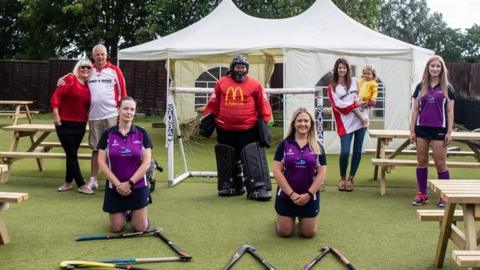 Philip Taylor with his partner Lynda, daughter Tanya and his grand-daughter with members of the Loddon ladies hockey team that he sponsors