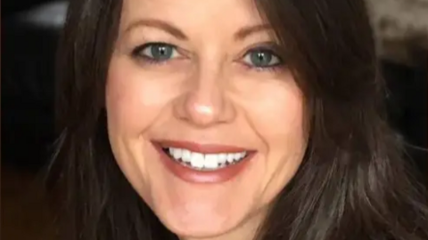 Amanda Rees smiling, she has dark hair