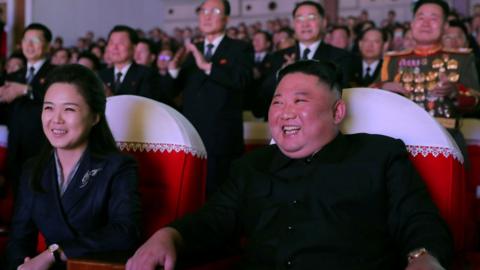 North Korean leader Kim Jong Un and his wife Ri Sol Ju watch a performance that commemorated the Day of the Shining Star