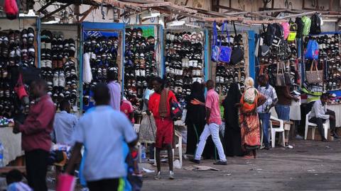 A vendor sits next to his shop as he waits for customers in Djibouti
