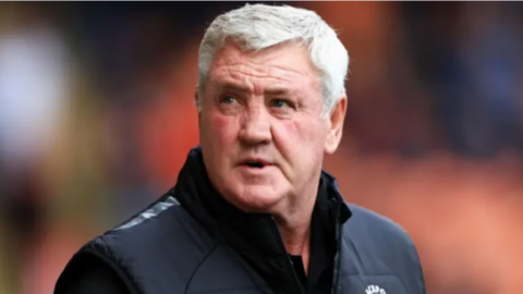 Image shows former football manager and player Steve Bruce pitch-side during a match.
