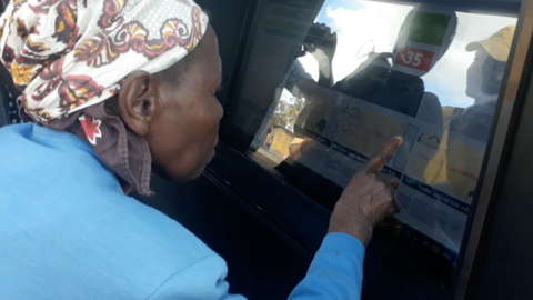 Woman using the community tablet