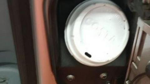 The coffee lid in place on the taxi