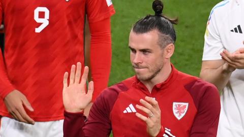 Gareth Bale waves as he leaves the field following Wales' defeat by England at the 2022 World Cup in Qatar