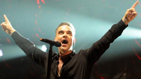 Robbie Williams performing