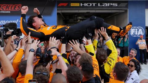 Lando Norris 'crowd-surfs' in celebration with McLaren mechanics after winning the Miami Grand Prix