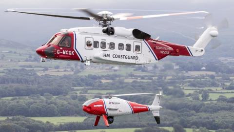 The Sikorsky S92 Bristow HM Coastguard search and rescue helicopter flying with a HM Coastguard Schiebel Camcopter S-100