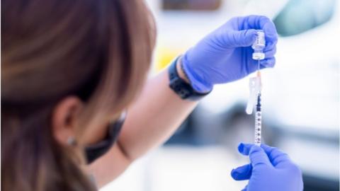 A woman preparing a vaccine