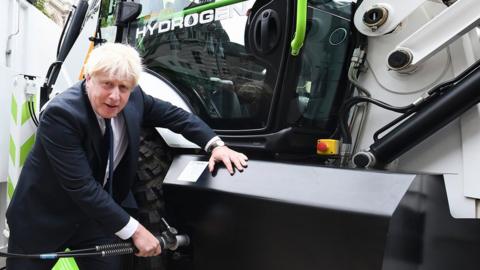 Prime Minister Boris Johnson refuels JCB's prototype hydrogen powered backhoe loader
