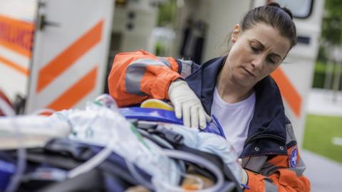 Female paramedic with patient