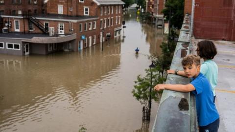 Child looking over flooded city