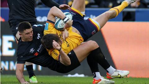 Ethan McIlroy of Ulster is tackled by Owen Watkin of Ospreys