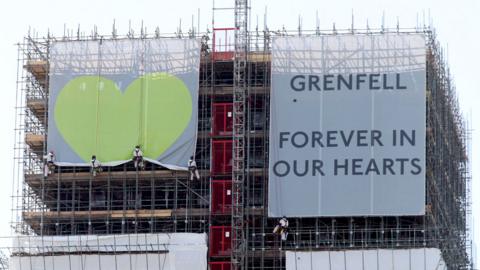 Banners on the outside of Grenfell Tower