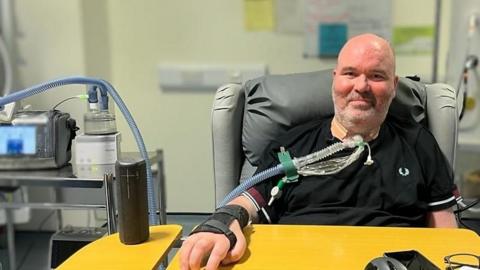 Brian Murphy sitting in hospital