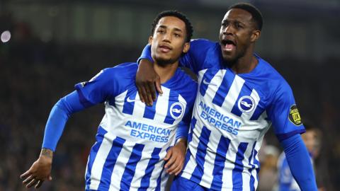 Joao Pedro celebrates with Danny Welbeck after scoring Brighton's second goal against Tottenham