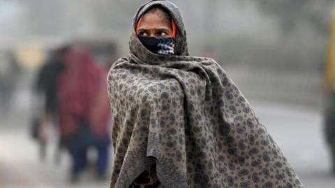 People seen wearing warm clothes on a cold morning at sector 59 on January 4, 2023 in Noida, India. The India Meteorological Department (IMD) has predicted prevalence of severe cold weather conditions, along with dense to very dense fog over northwest India during the next four to five days.