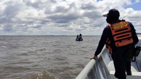 A handout photo made available by the Colombian Navy showing a group of coast guards participating in the search for the missing persons, after the collision of two artisanal boats, in Tumaco, Colombia, 01 February 2021.