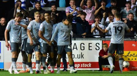 Reading players celebrate scoring against Exeter City in the EFL Trophy.