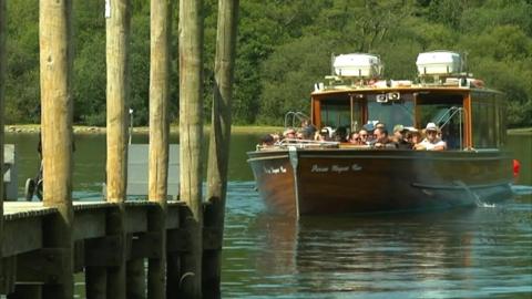 A boat approaches the docking platform in Keswick