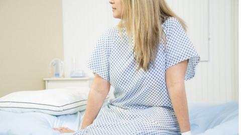 Woman in doctor's office for check up. - stock photo