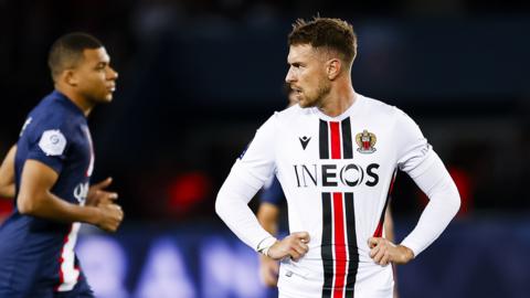 Nice's Aaron Ramsey stares at Kyllian Mbappe of PSG