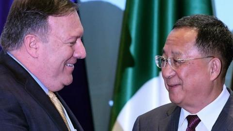 US Secretary of State Mike Pompeo smiles with North Korean Foreign Minister Ri Yong-ho