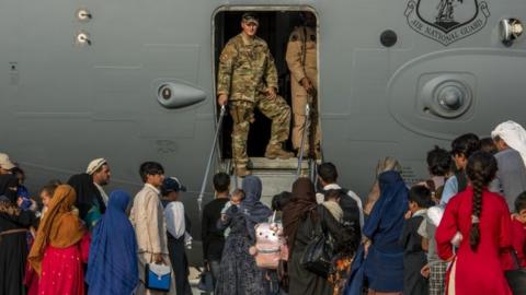 People boarding US military airplane