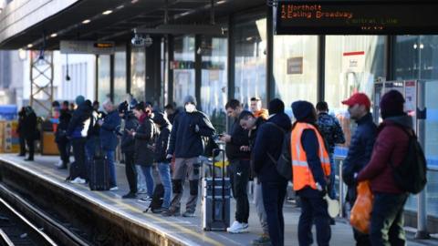 Commuters waiting at a Tube platform