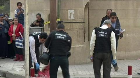 Police search the area around the church in southern Cairo on 29 December 2017